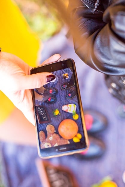 A user scrolling through a visually engaging Instagram feed on a smartphone, with a focus on vibrant and eye-catching images and videos.