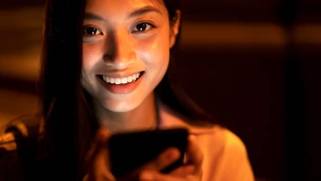 A close-up shot of a person smiling while interacting with a brand's engaging social media post on their smartphone. The post features a vibrant image and a compelling question, inviting the user to share their opinion. The focus is on the genuine enjoyment and connection the user experiences while engaging with the content.